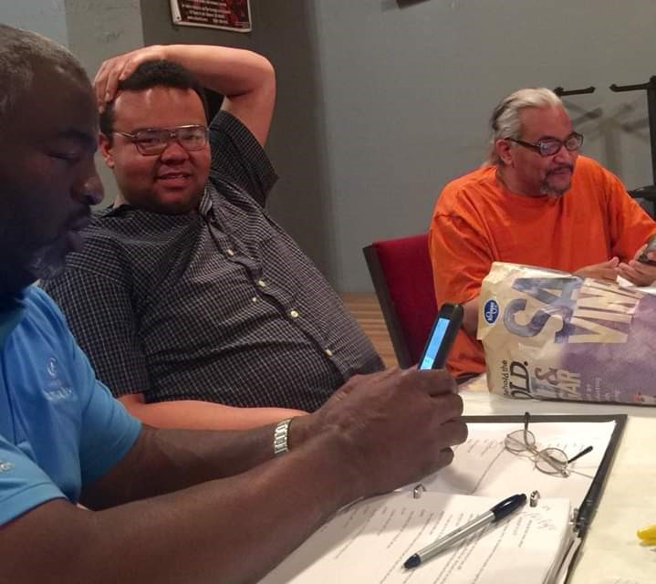 Jon Sayles at a writers table